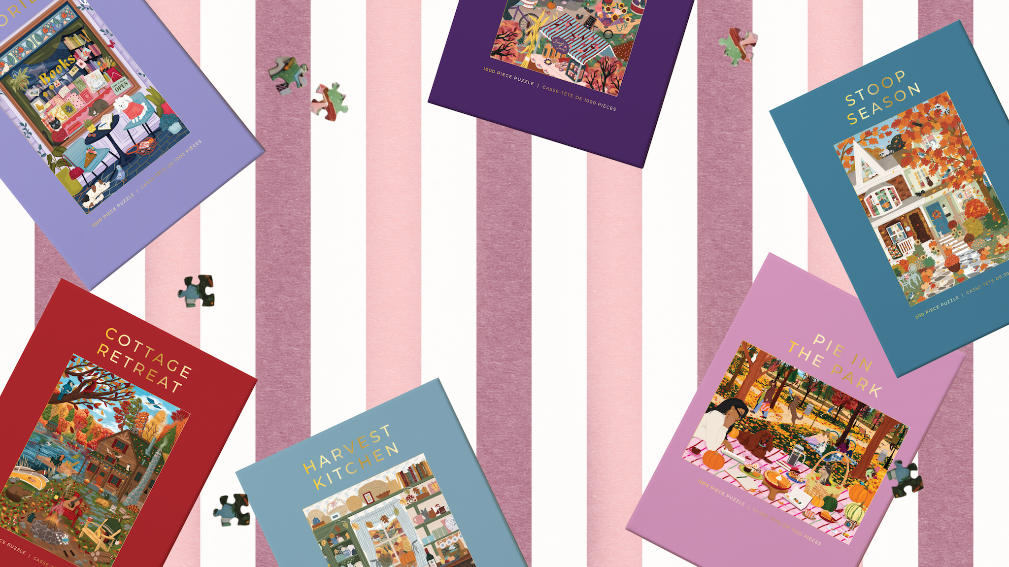 Six illustrated book covers or boxes are arranged on a pink and white striped background, each with a different cover color and a small jigsaw puzzle piece near it. Visible titles include Cottage Retreat, Harvest Kitchen, Stoop Season, and Pie in the Park.
