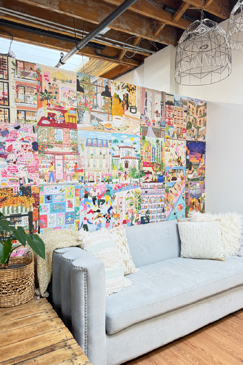 The Hobbry Studio with a colorful collage wall art and a light gray sofa.