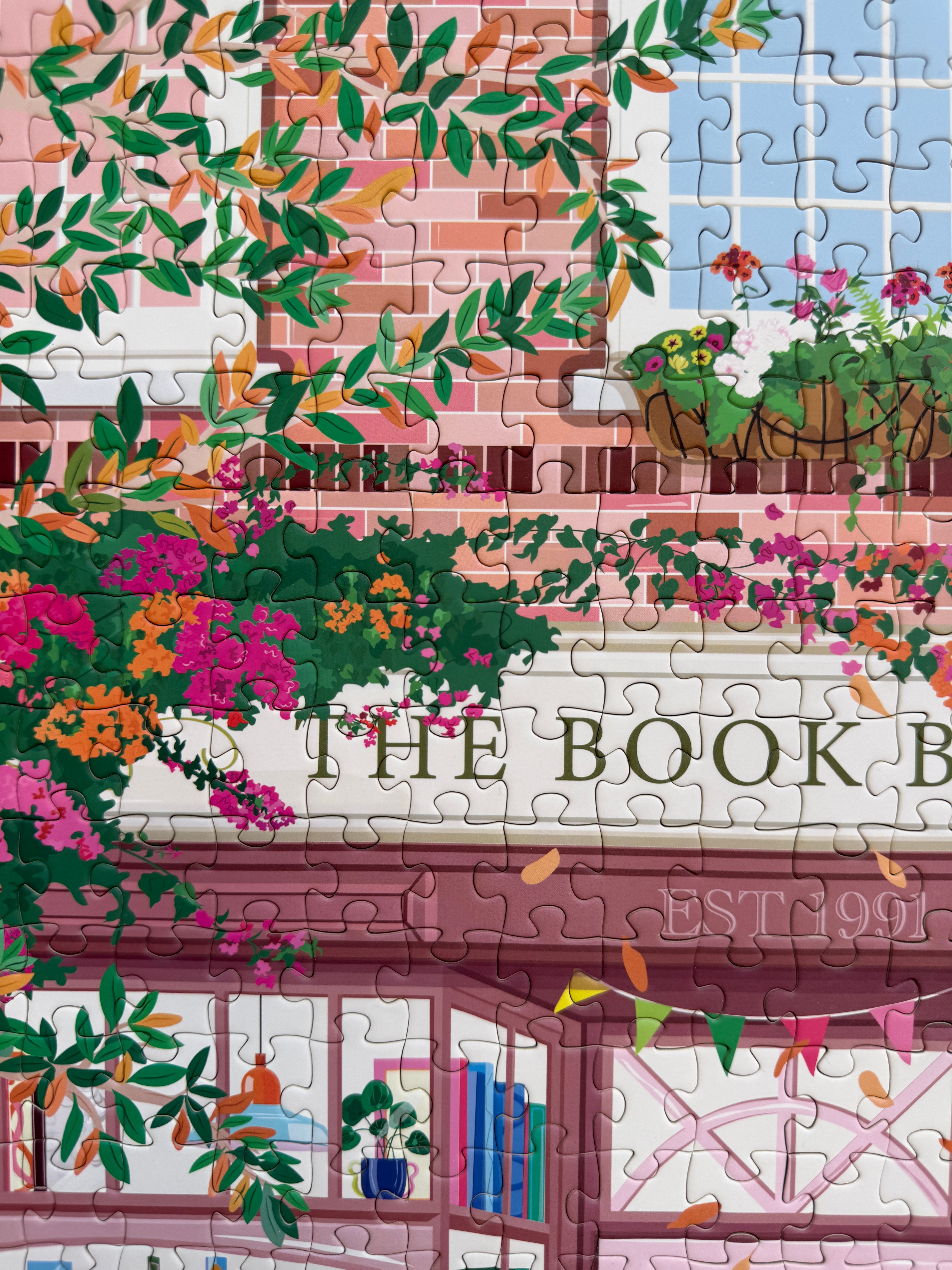Jigsaw puzzle with a colorful design of a bookshop exterior.